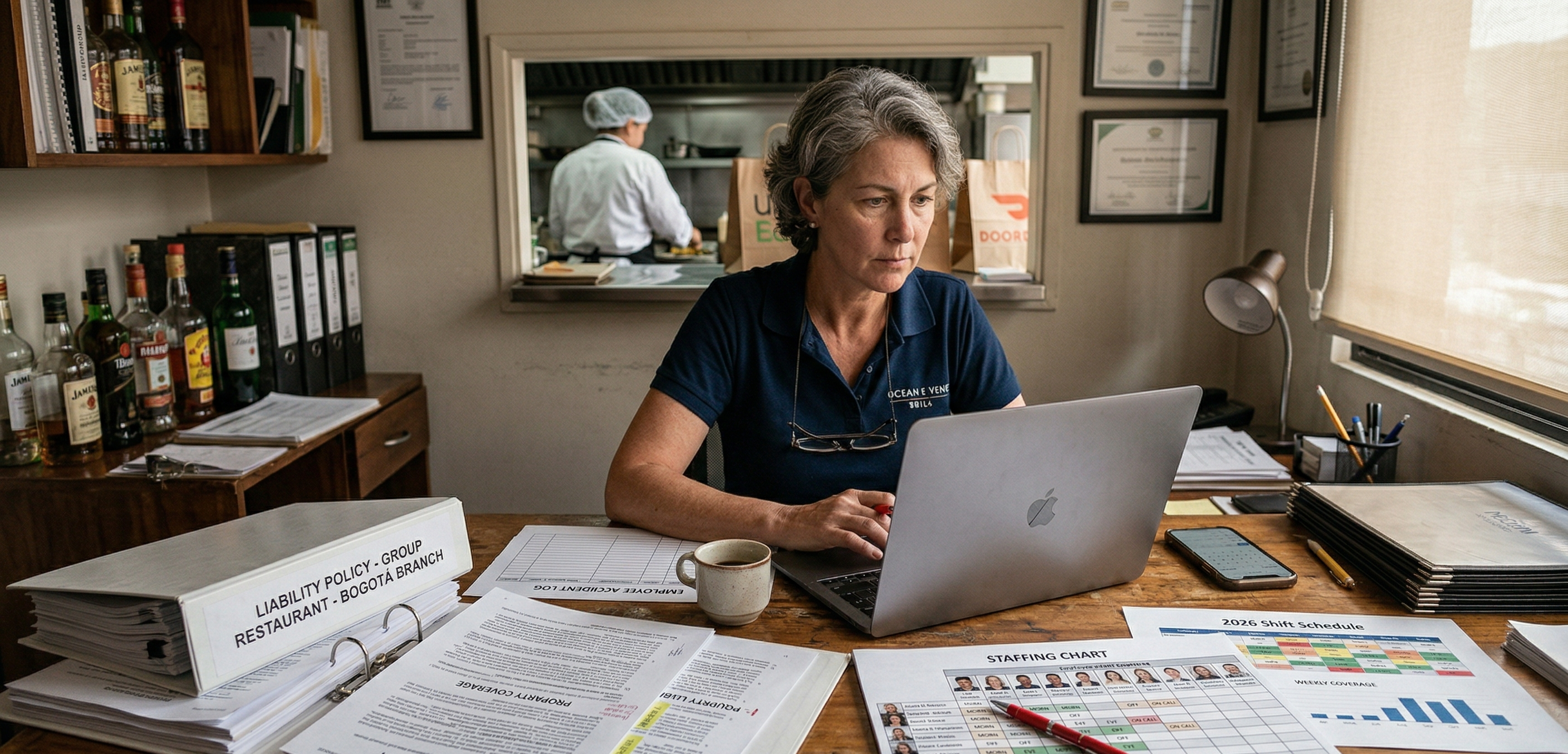Restaurant manager comparing staffing and insurance documents to identify a restaurant insurance mismatch